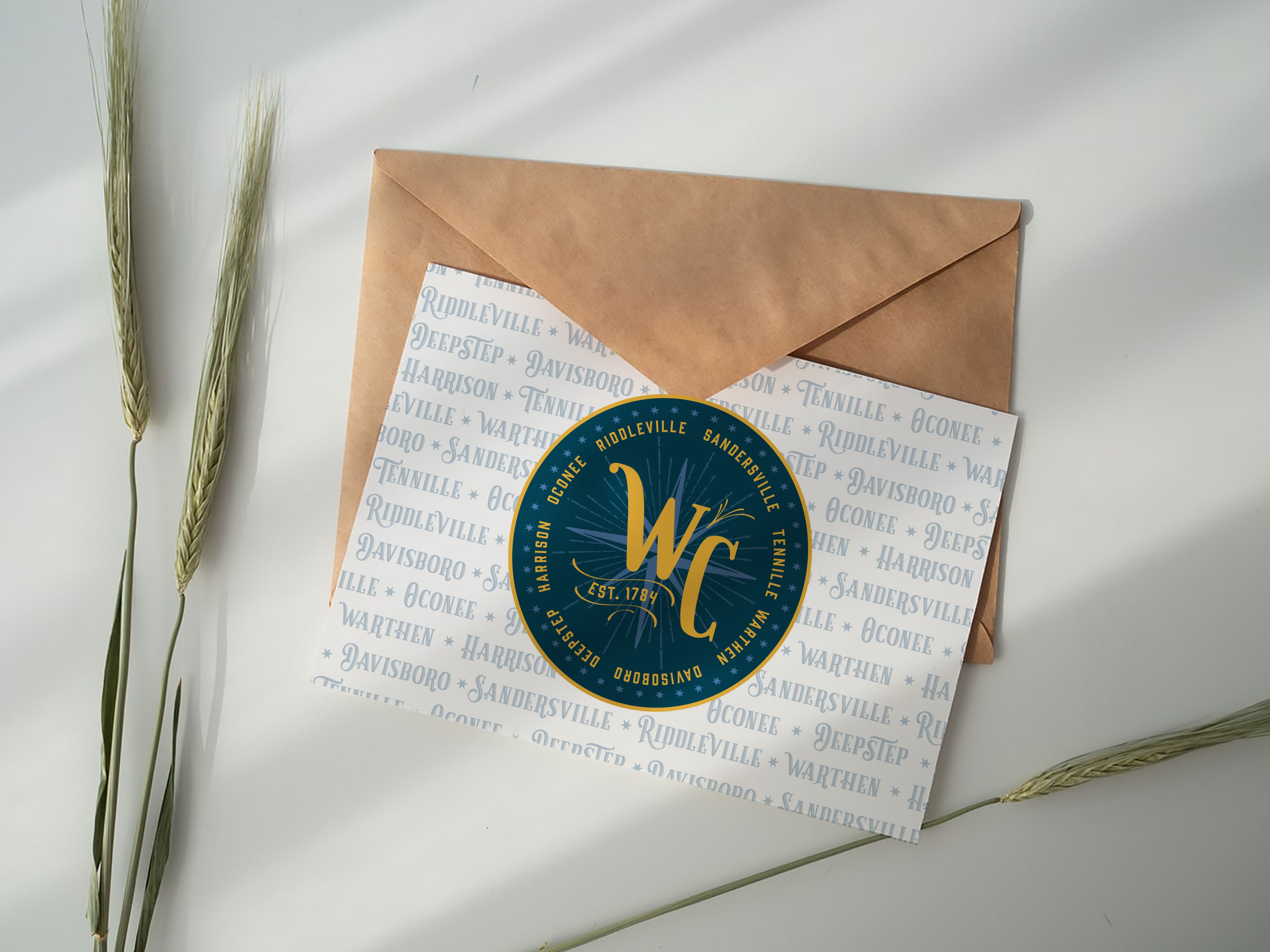 A notecard printed with the Washington County brand, a gold W and C on a dark blue background, is shown.