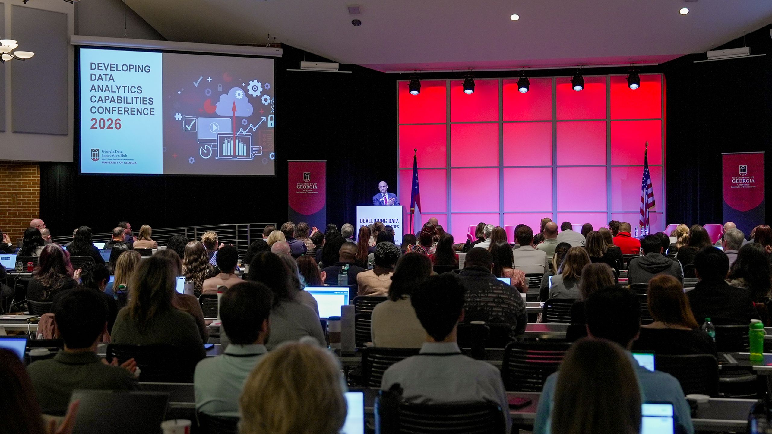 Hundreds of professionals fill the seats during a plenary session.